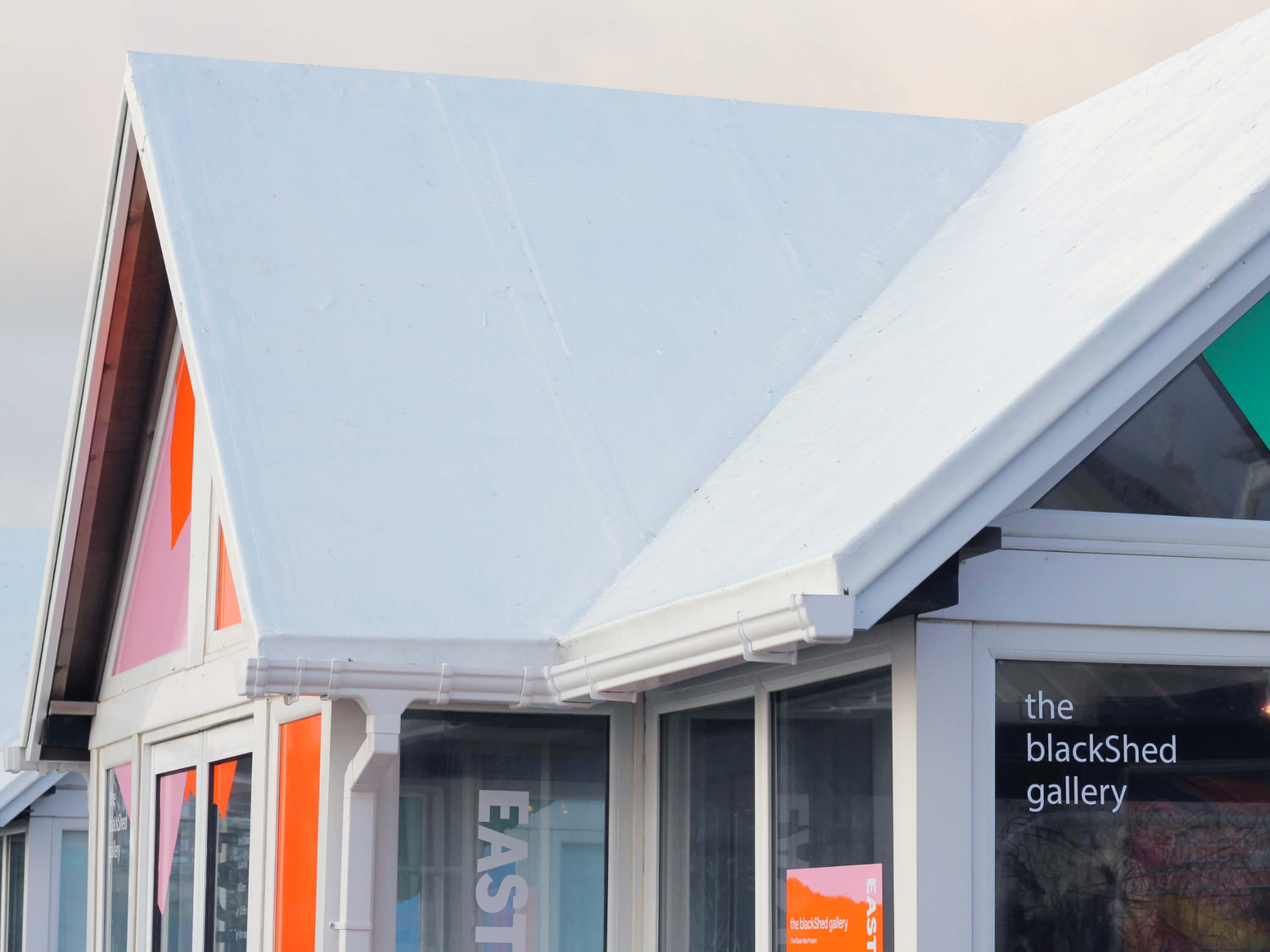 Windown vinyls for the blackShed gallery exhibition on Eastbourne Pier, designed by Two Pens