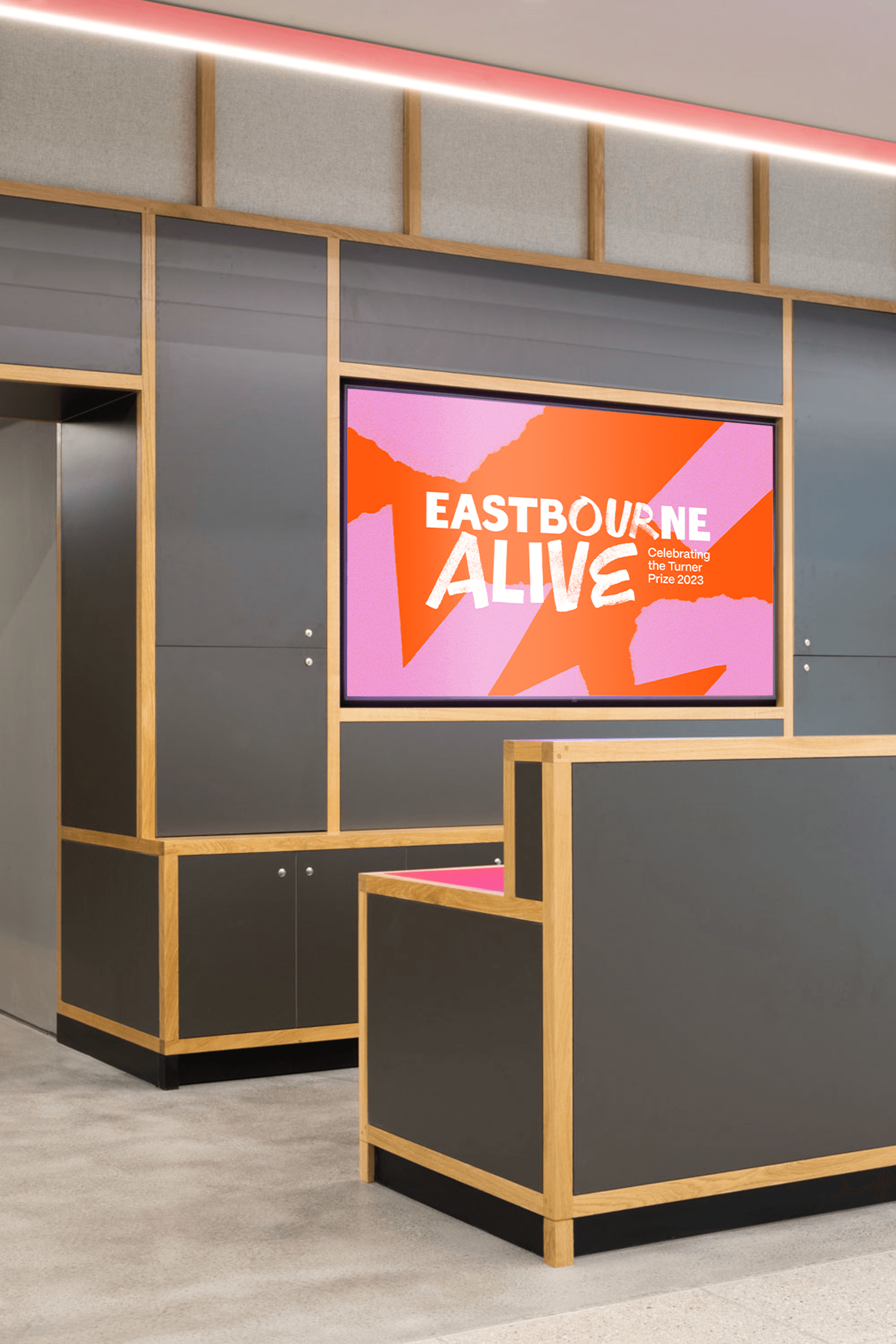 Eastbourne Alive logo on screen in the Towner Eastbourne foyer, design by Two Pens 