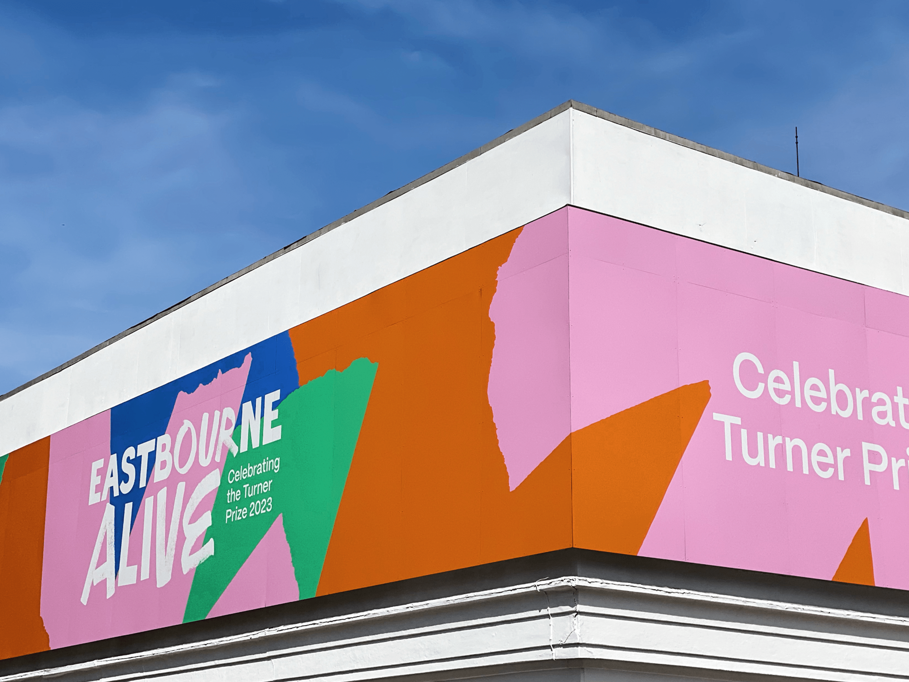 Eastbourne Alive visual identiy printed onto the hoardings at the Eastbourne Winter Garden, design by Two Pens