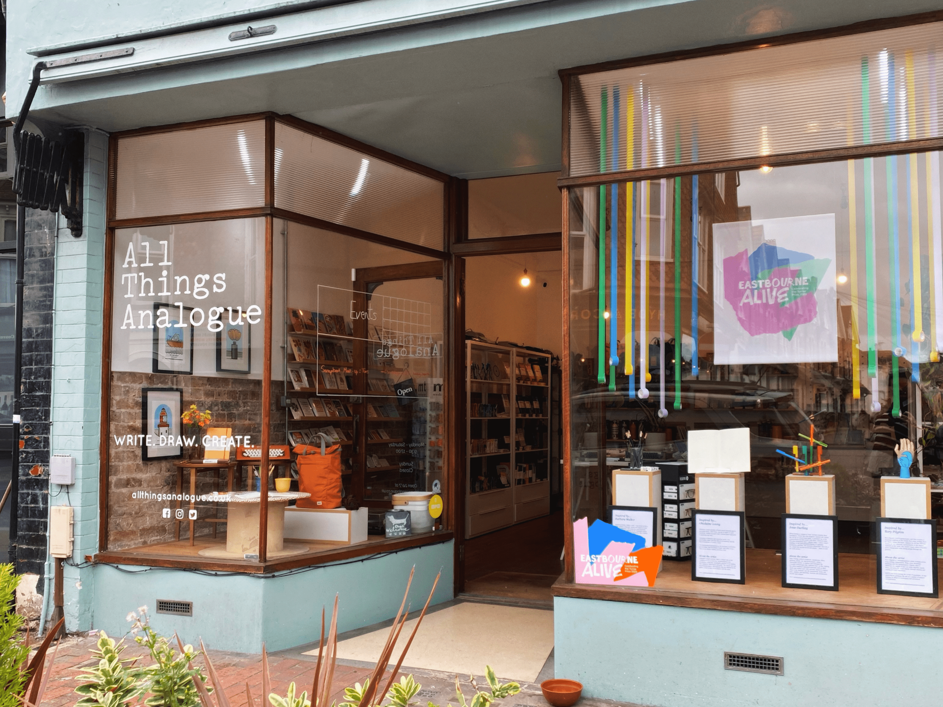 Eastbourne Alive vinyls and branding on display in the windows of All Things Analogue, Eastbourne