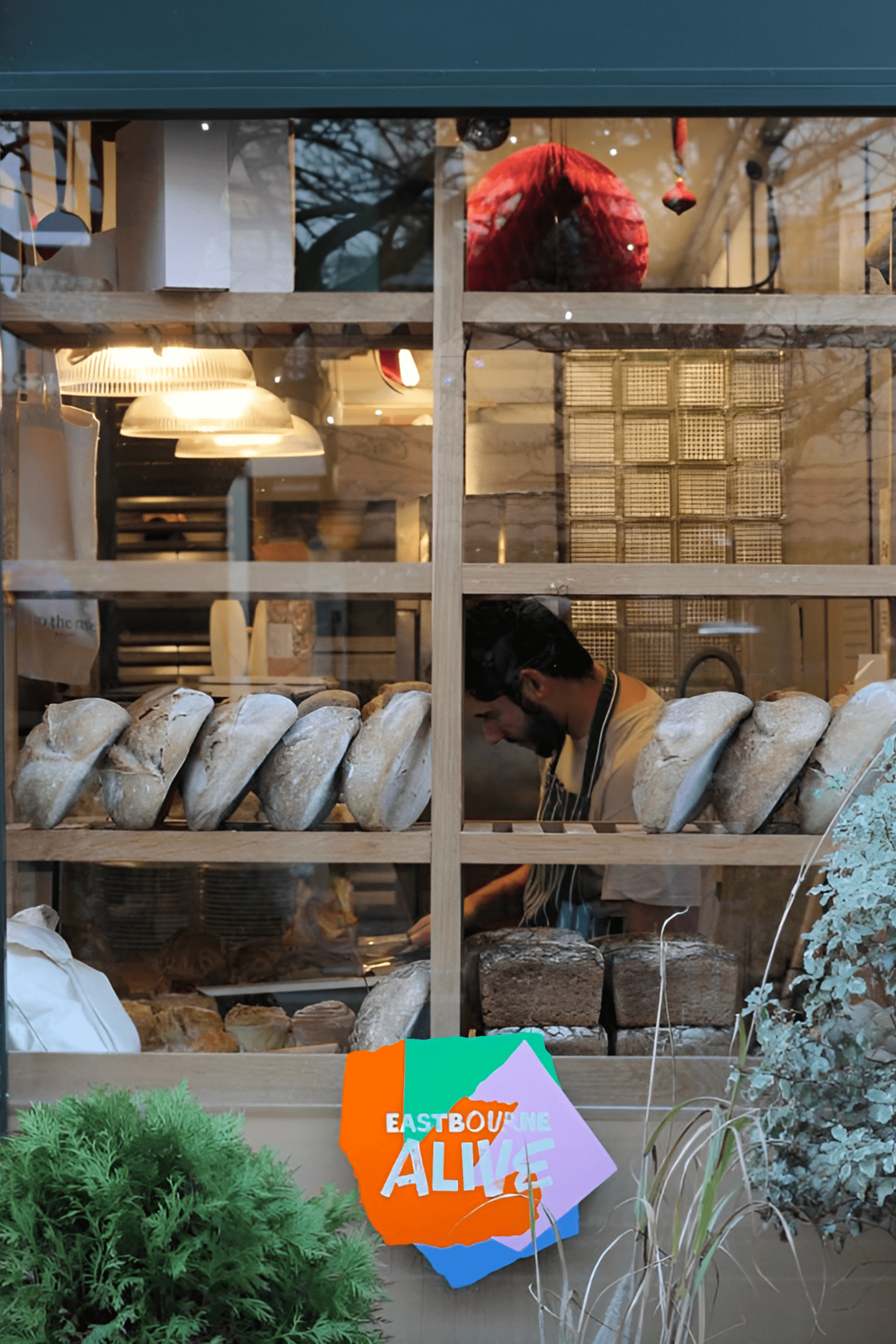 Eastbourne Alive window vinyl shown in the window of To The Rise bakery on terminus road. 