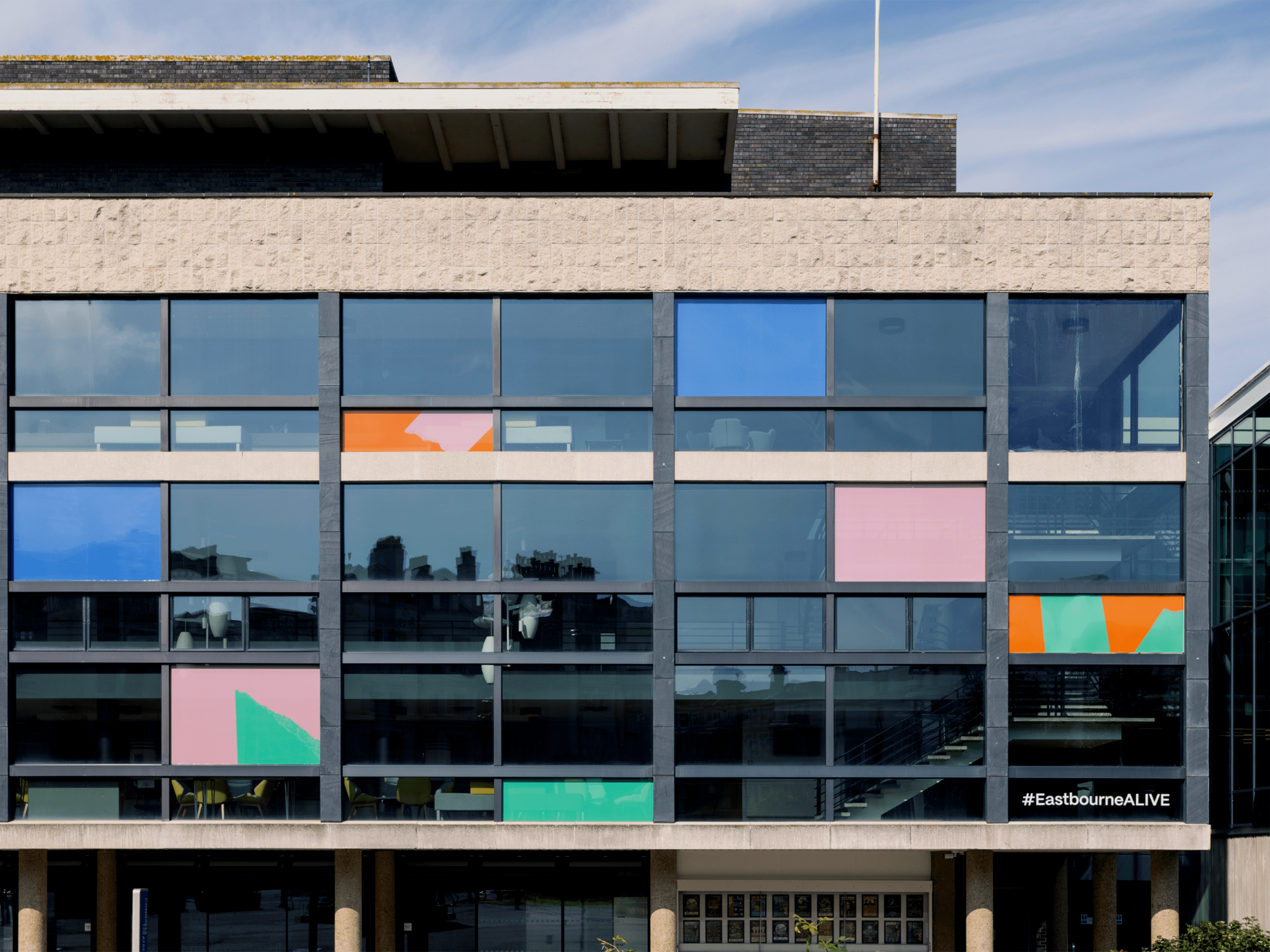 Eastbourne Alive vinyls dotted across the front of the Congress Theatre, designed by Two Pens 