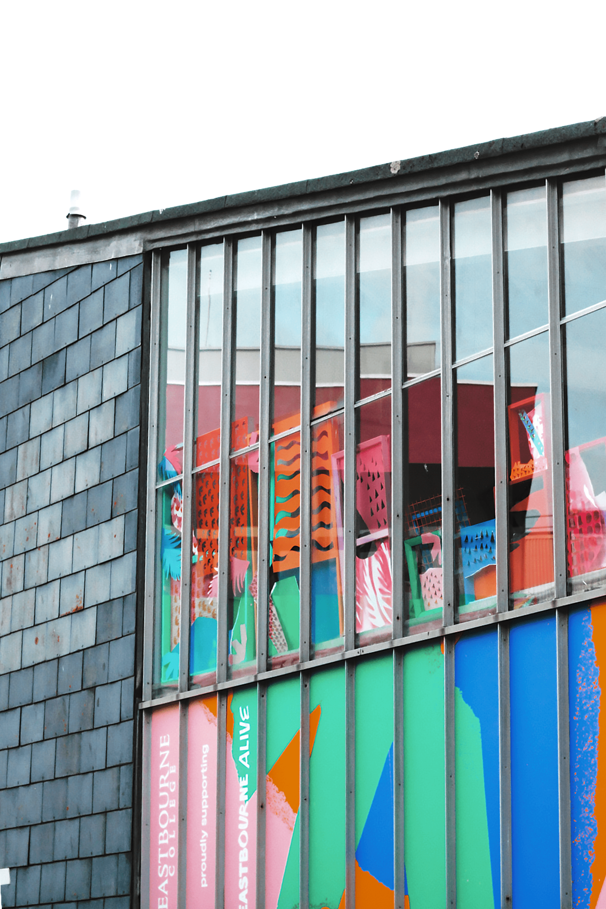 Eastbourne Alive vinyls at in the windows at Eastbourne College, designed by Two Pens